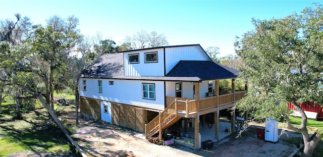 back of house featuring a wooden deck