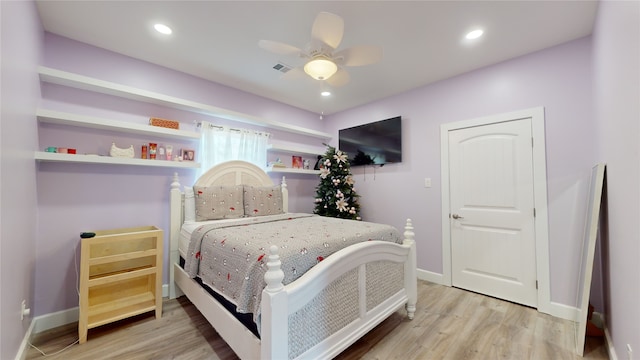 bedroom with ceiling fan and light wood-type flooring