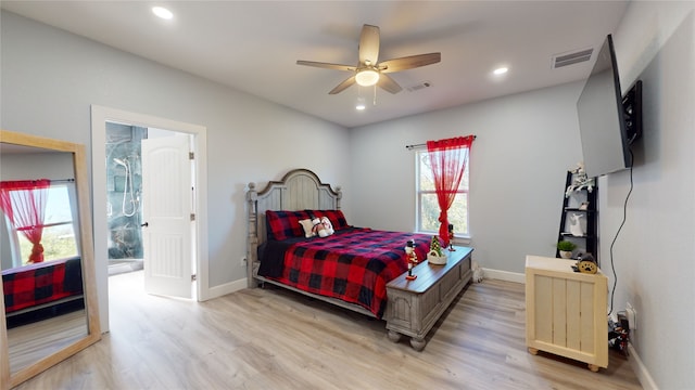 bedroom featuring light hardwood / wood-style flooring, ceiling fan, and multiple windows