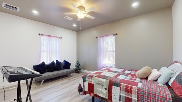 bedroom with ceiling fan and light wood-type flooring