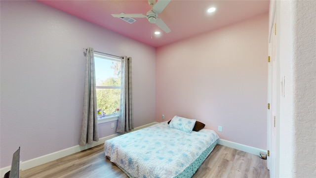 bedroom with ceiling fan and light wood-type flooring