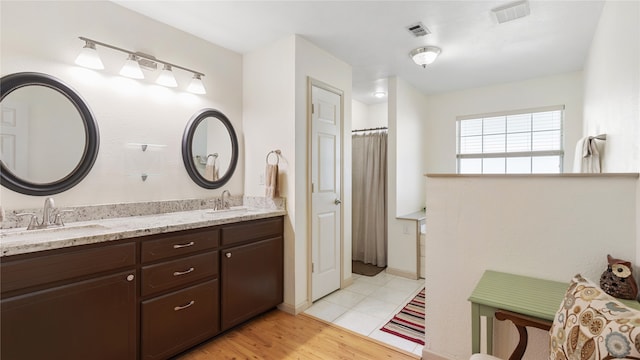 bathroom with wood-type flooring and vanity