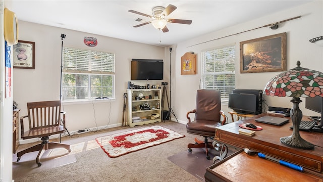 carpeted home office featuring ceiling fan and plenty of natural light