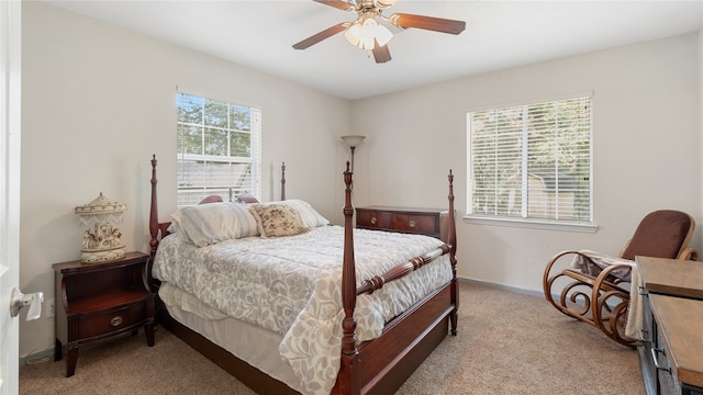 bedroom with ceiling fan and light colored carpet