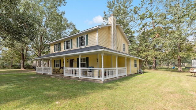 farmhouse featuring a porch and a front lawn