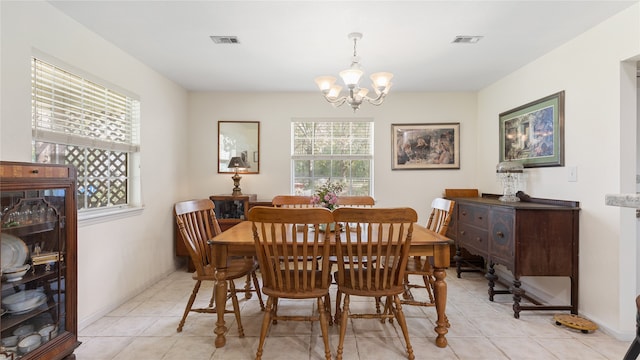 dining area with light tile patterned floors, a chandelier, and a healthy amount of sunlight