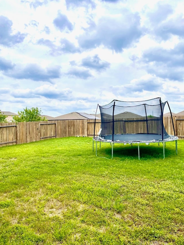 view of yard with a trampoline