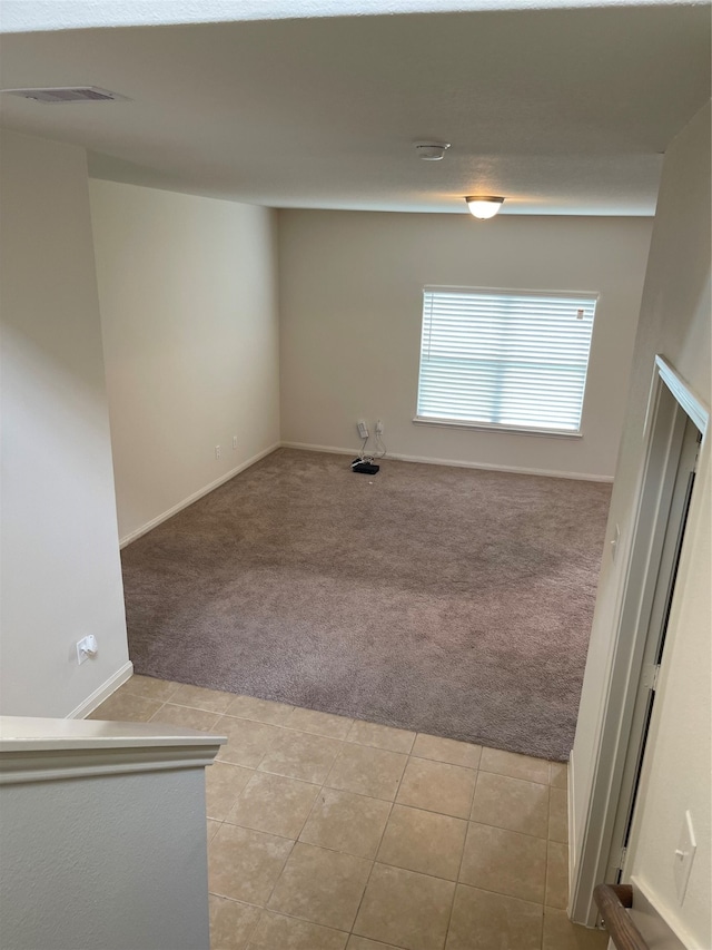 spare room with light colored carpet