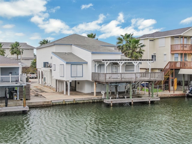 view of dock featuring a balcony and a water view