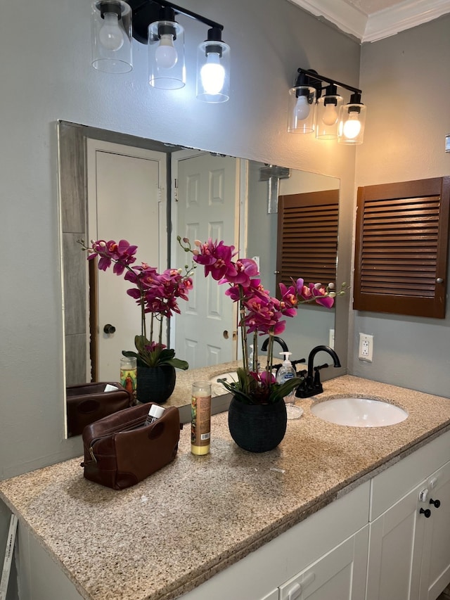 bathroom with crown molding and vanity