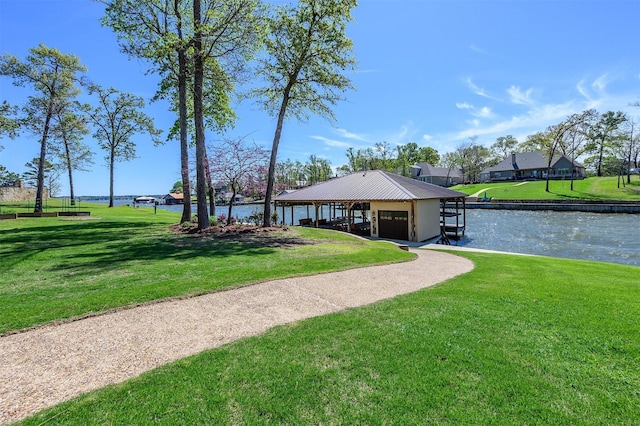 view of property's community with a water view, a yard, and a gazebo