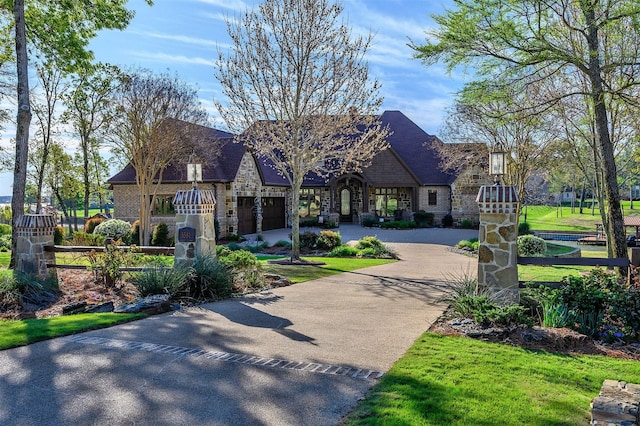 view of front of house with a garage and a front lawn