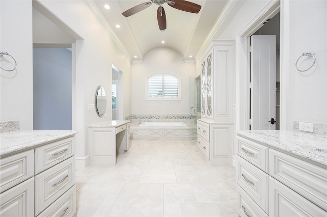 bathroom featuring vanity, a relaxing tiled tub, and ceiling fan