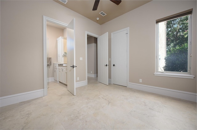 unfurnished bedroom featuring connected bathroom and ceiling fan