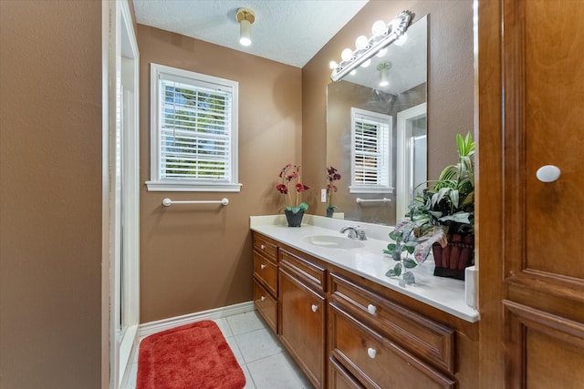 bathroom featuring vanity, tile patterned floors, a textured ceiling, and walk in shower