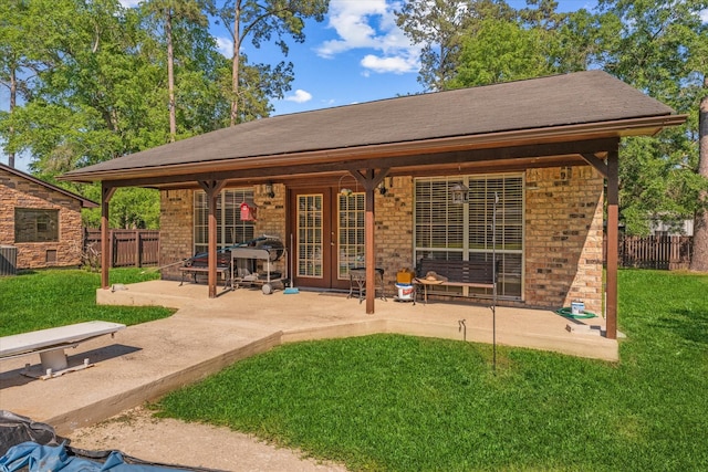 back of property with a patio, cooling unit, and a lawn