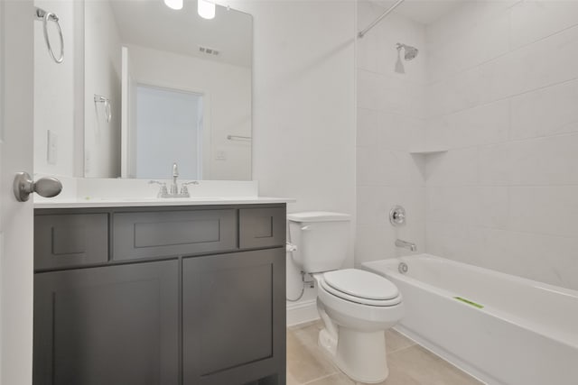 full bathroom with vanity, tile patterned floors, tiled shower / bath, and toilet