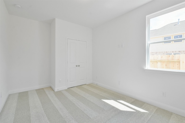 carpeted spare room with a healthy amount of sunlight