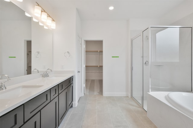 bathroom with tile patterned flooring, independent shower and bath, and vanity