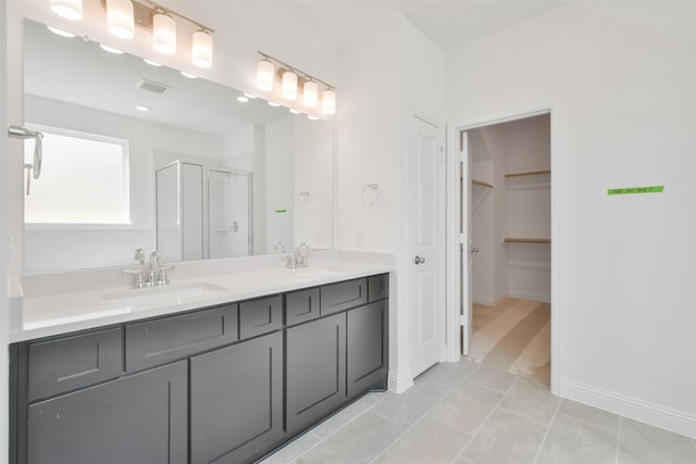 bathroom with vanity, tile patterned flooring, and a shower with shower door