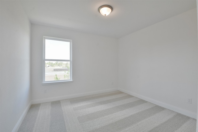 unfurnished room with light colored carpet