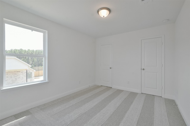 empty room with light colored carpet