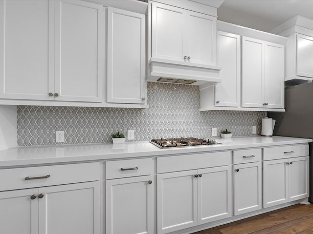 kitchen featuring dark hardwood / wood-style flooring, stainless steel gas stovetop, and white cabinetry