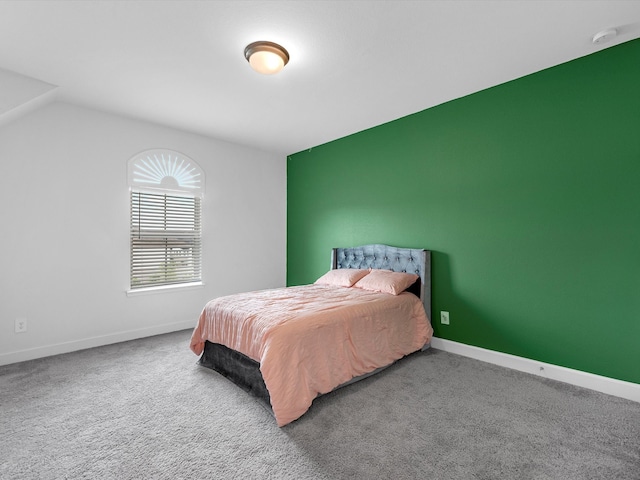 bedroom with dark colored carpet