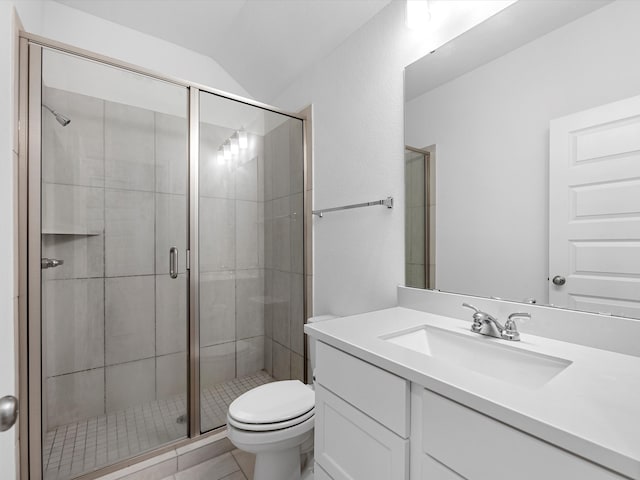 bathroom with tile flooring, toilet, vanity, walk in shower, and vaulted ceiling