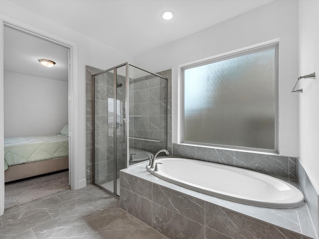 bathroom featuring shower with separate bathtub and tile flooring