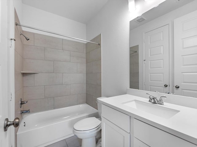 full bathroom with tile flooring, toilet, vanity, and tiled shower / bath