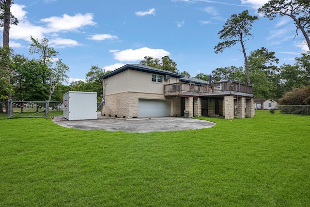 back of house featuring a garage, a yard, and a patio