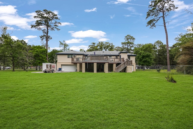 back of property featuring a lawn and a deck