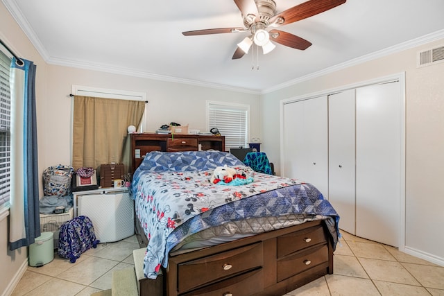 tiled bedroom featuring ceiling fan, a closet, and ornamental molding