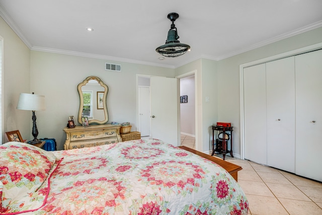 bedroom featuring a chandelier, a closet, ornamental molding, and light tile floors