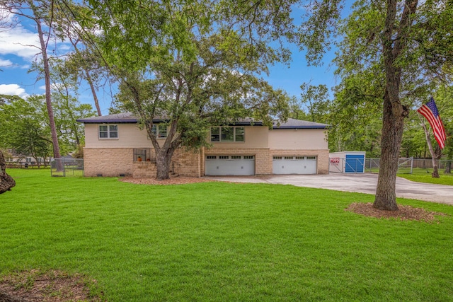 view of front of property featuring solar panels, a front lawn, and a garage