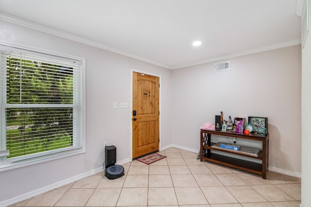 entryway with crown molding, a wealth of natural light, and light tile flooring