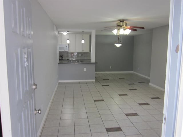 unfurnished room featuring ceiling fan and light tile floors