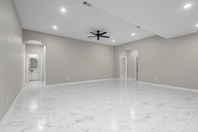 tiled spare room with ceiling fan