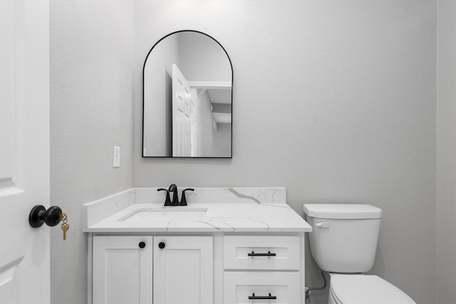 bathroom with toilet and vanity