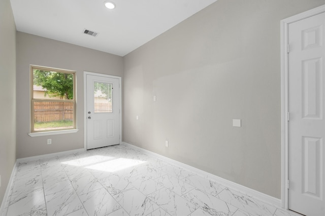 doorway to outside with light tile floors