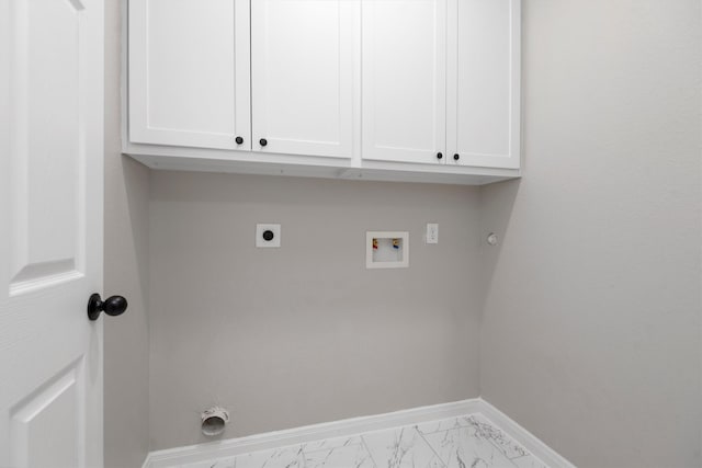 clothes washing area featuring electric dryer hookup, washer hookup, light tile flooring, hookup for a gas dryer, and cabinets