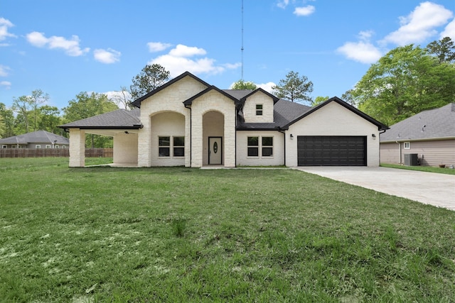 french provincial home featuring a front yard, central AC, and a garage