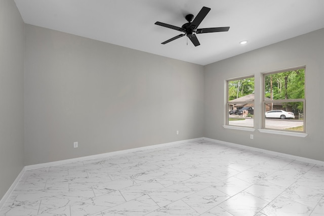 empty room with ceiling fan and light tile floors