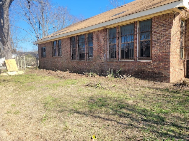 view of side of home featuring a lawn