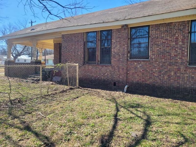 view of side of home featuring a yard