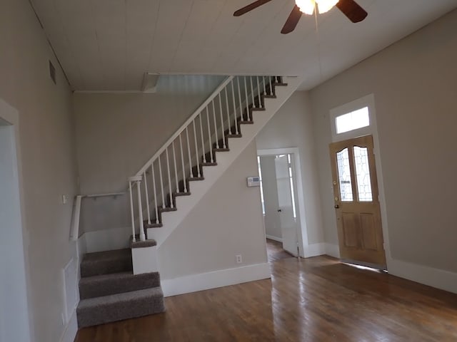 foyer with ceiling fan and dark wood-type flooring