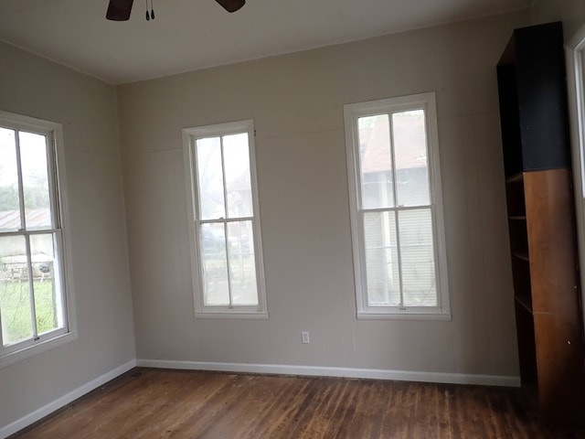 unfurnished room with ceiling fan and dark hardwood / wood-style floors