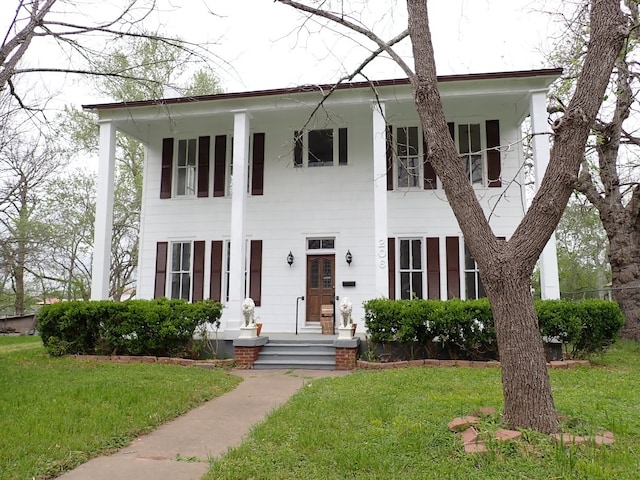 view of front of property with a porch and a front yard