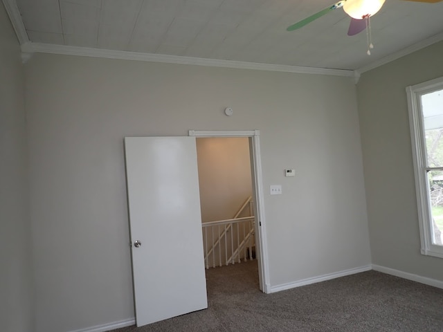 carpeted empty room featuring crown molding and ceiling fan